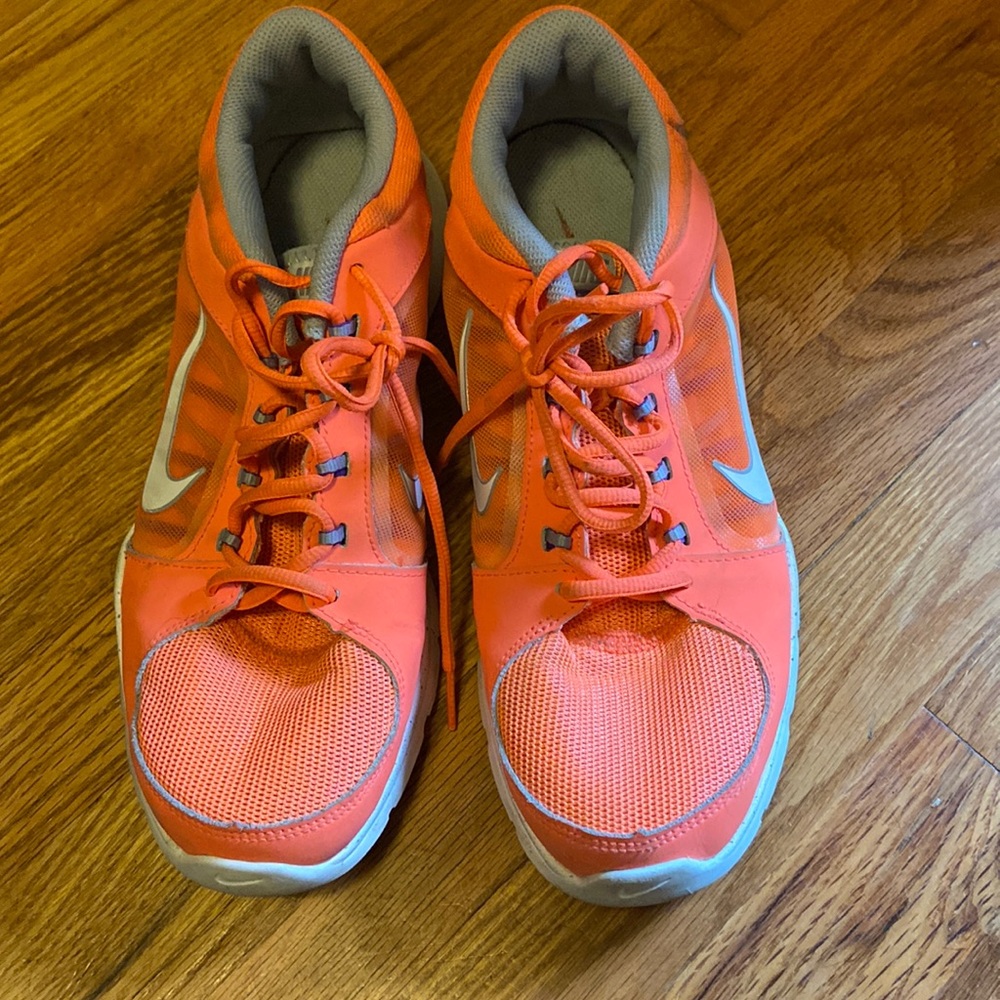 Orange Nike athletic shoes